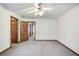 Neutral bedroom with ceiling fan and plush carpet, creating a cozy space at 558 Auburn Rd, Auburn, GA 30011