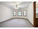 Bright bedroom with three windows offering natural light and neutral carpet at 558 Auburn Rd, Auburn, GA 30011