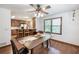 Bright dining area with hardwood floors, access to the kitchen, and a large window at 558 Auburn Rd, Auburn, GA 30011