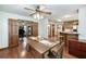 Cozy dining room featuring hardwood floors, a ceiling fan, and easy access to the kitchen at 558 Auburn Rd, Auburn, GA 30011