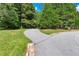 Gravel driveway winding through a lush, green landscape, offering privacy and charm at 558 Auburn Rd, Auburn, GA 30011