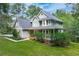 Exterior view of a gray two-story home with a wraparound porch and lush landscaping at 558 Auburn Rd, Auburn, GA 30011