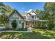 Charming two-story home with a welcoming front porch and well-manicured lawn and mature trees at 558 Auburn Rd, Auburn, GA 30011