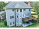 Two-story home featuring a wooden deck and basement access at 558 Auburn Rd, Auburn, GA 30011
