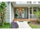 Close-up of the home's entrance, featuring an oval glass front door and a covered porch at 558 Auburn Rd, Auburn, GA 30011