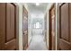 Hallway view leading to a bathroom showcasing a large soaking tub under an arched window at 558 Auburn Rd, Auburn, GA 30011