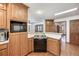 Classic kitchen view featuring wood cabinets and a built-in microwave and electric range at 558 Auburn Rd, Auburn, GA 30011