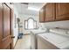 Bright laundry room with modern appliances, storage cabinets, and plenty of workspace at 558 Auburn Rd, Auburn, GA 30011