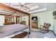 Spacious bedroom featuring a canopy bed, soft green walls, and a ceiling fan at 558 Auburn Rd, Auburn, GA 30011