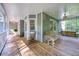 Inviting covered porch with swing, ceiling fan, and rocking chairs for relaxing outdoor living at 558 Auburn Rd, Auburn, GA 30011