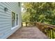 Spacious wooden deck overlooking a lush backyard and mature trees at 558 Auburn Rd, Auburn, GA 30011