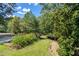 A beautifully landscaped yard surrounded by mature trees and greenery, perfect for outdoor enjoyment at 558 Auburn Rd, Auburn, GA 30011