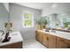 Bright bathroom featuring double sinks, wood cabinetry, and contemporary fixtures at 1432 Wicker Wood Se Pl # 9, Smyrna, GA 30080