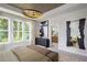 Bright bedroom with large windows, designer lighting, and a decorative mirror over the dresser at 1432 Wicker Wood Se Pl # 9, Smyrna, GA 30080