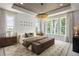 Bright primary bedroom featuring a statement ceiling, large windows, and stylish furnishings at 1432 Wicker Wood Se Pl # 9, Smyrna, GA 30080