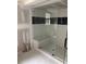 Modern bathroom showcasing a new walk-in shower with glass door and tile surround with dark accent row at 2256 Mack Rd, Douglasville, GA 30135