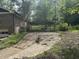 Exterior view featuring long driveway leading to brick home with covered parking at 2256 Mack Rd, Douglasville, GA 30135