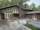 Exterior shot of the home's back showing the pool area and the yard's potential at 2256 Mack Rd, Douglasville, GA 30135