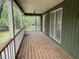 Covered porch featuring wooden floors and ample space for outdoor relaxation at 2256 Mack Rd, Douglasville, GA 30135