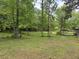 Expansive green yard with mature trees offering a serene and natural setting at 2256 Mack Rd, Douglasville, GA 30135