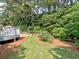 The backyard has a lush lawn with a stone path leading to a wood deck at 2308 Littlebrooke Dr, Dunwoody, GA 30338