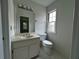 This well-lit bathroom includes a vanity with a large mirror, and a toilet at 2308 Littlebrooke Dr, Dunwoody, GA 30338