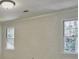 This bedroom has a textured wall and includes two windows at 2308 Littlebrooke Dr, Dunwoody, GA 30338