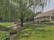 View of the community park, a stream, and tennis courts with a green grass surround at 2308 Littlebrooke Dr, Dunwoody, GA 30338