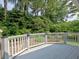 Wooden deck overlooking mature trees and professional landscaping at 2308 Littlebrooke Dr, Dunwoody, GA 30338