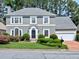 Charming gray two-story home with manicured lawn and brick driveway at 2308 Littlebrooke Dr, Dunwoody, GA 30338