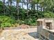Outdoor stone fireplace on the backyard patio at 2308 Littlebrooke Dr, Dunwoody, GA 30338