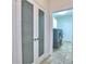 Hallway view to laundry room with frosted glass pantry doors at 2308 Littlebrooke Dr, Dunwoody, GA 30338