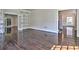 Spacious living room with hardwood floors and multiple entryways to other rooms at 2308 Littlebrooke Dr, Dunwoody, GA 30338