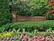 Landscaped entrance to Brooke Farm neighborhood with brick sign and horse emblem at 2308 Littlebrooke Dr, Dunwoody, GA 30338