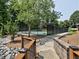 Community tennis court surrounded by lush greenery with accessible path ways and tiered landscaping at 2308 Littlebrooke Dr, Dunwoody, GA 30338