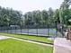 View of well-maintained community tennis courts, framed by tall trees, offering a great recreational amenity at 2308 Littlebrooke Dr, Dunwoody, GA 30338