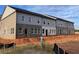 New construction townhomes with mixed brick and siding facade, modern windows, and clean lines on a sunny day at 3104 Marbella Cir # 2, Kennesaw, GA 30152