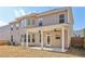 Expansive backyard featuring a covered patio, large windows, and a well-manicured lawn at 1147 Trident Maple Chase, Lawrenceville, GA 30045