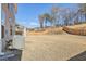 Large backyard with a wooden fence, a gently sloping landscape, and mature trees at 1147 Trident Maple Chase, Lawrenceville, GA 30045