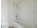 Bathroom with tiled shower and tub combination with storage shelves at 1147 Trident Maple Chase, Lawrenceville, GA 30045