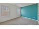 This bedroom features neutral carpet and blue accent wall at 1147 Trident Maple Chase, Lawrenceville, GA 30045