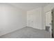 Neutral carpeted bedroom has closet and doorway at 1147 Trident Maple Chase, Lawrenceville, GA 30045