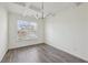 Bright dining room boasts gray wood floors, modern light fixture, and large window at 1147 Trident Maple Chase, Lawrenceville, GA 30045