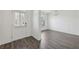 Open entryway with hardwood floors leading to a dining area with wainscoting detail at 1147 Trident Maple Chase, Lawrenceville, GA 30045