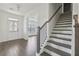 Inviting entryway features hardwood floors and staircase with dark wood accents and white trim at 1147 Trident Maple Chase, Lawrenceville, GA 30045
