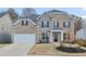 Charming two-story brick home with a two-car garage and well-manicured front yard at 1147 Trident Maple Chase, Lawrenceville, GA 30045