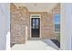 Close-up of the front door of the house, showing the brick facade at 1147 Trident Maple Chase, Lawrenceville, GA 30045