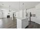 Bright open kitchen with island, stainless appliances, and hardwood flooring at 1147 Trident Maple Chase, Lawrenceville, GA 30045