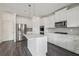 Bright kitchen with stainless steel appliances, a central island, and ample cabinet space at 1147 Trident Maple Chase, Lawrenceville, GA 30045