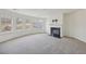 Cozy living room with fireplace, ceiling fan, and large windows at 1147 Trident Maple Chase, Lawrenceville, GA 30045